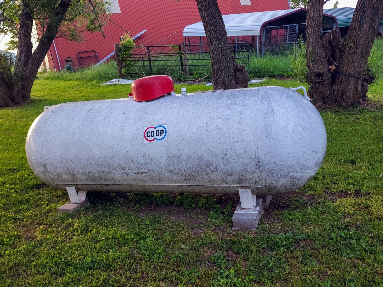 a large tank sitting in the middle of a field